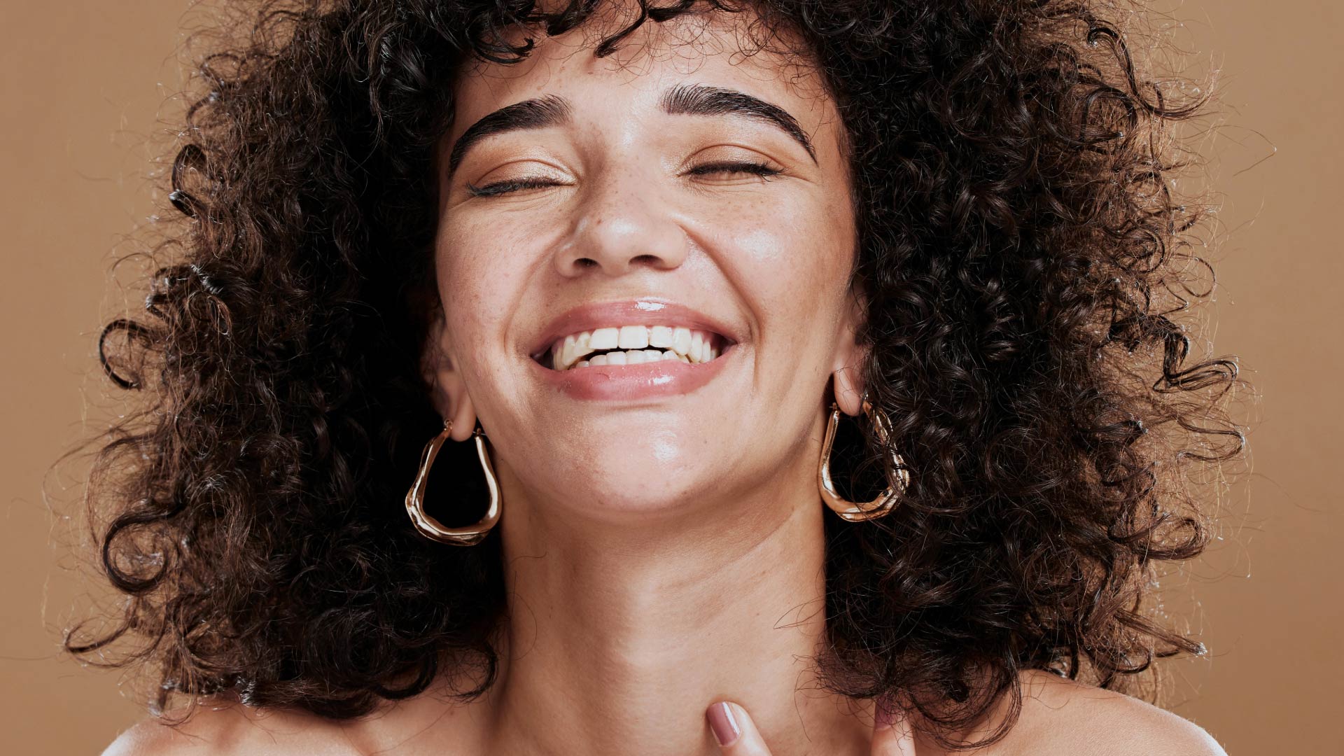 a woman with curly hair smiling
