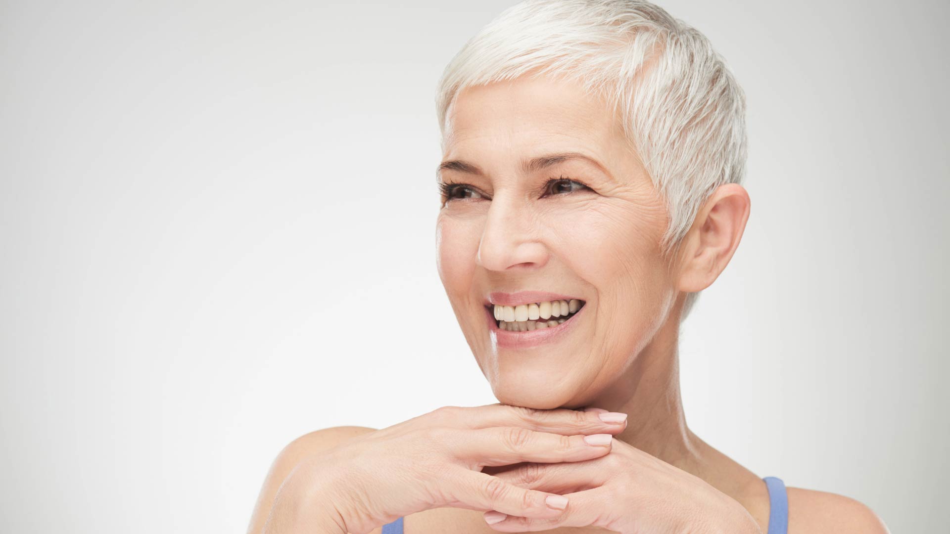 a woman with white hair smiling